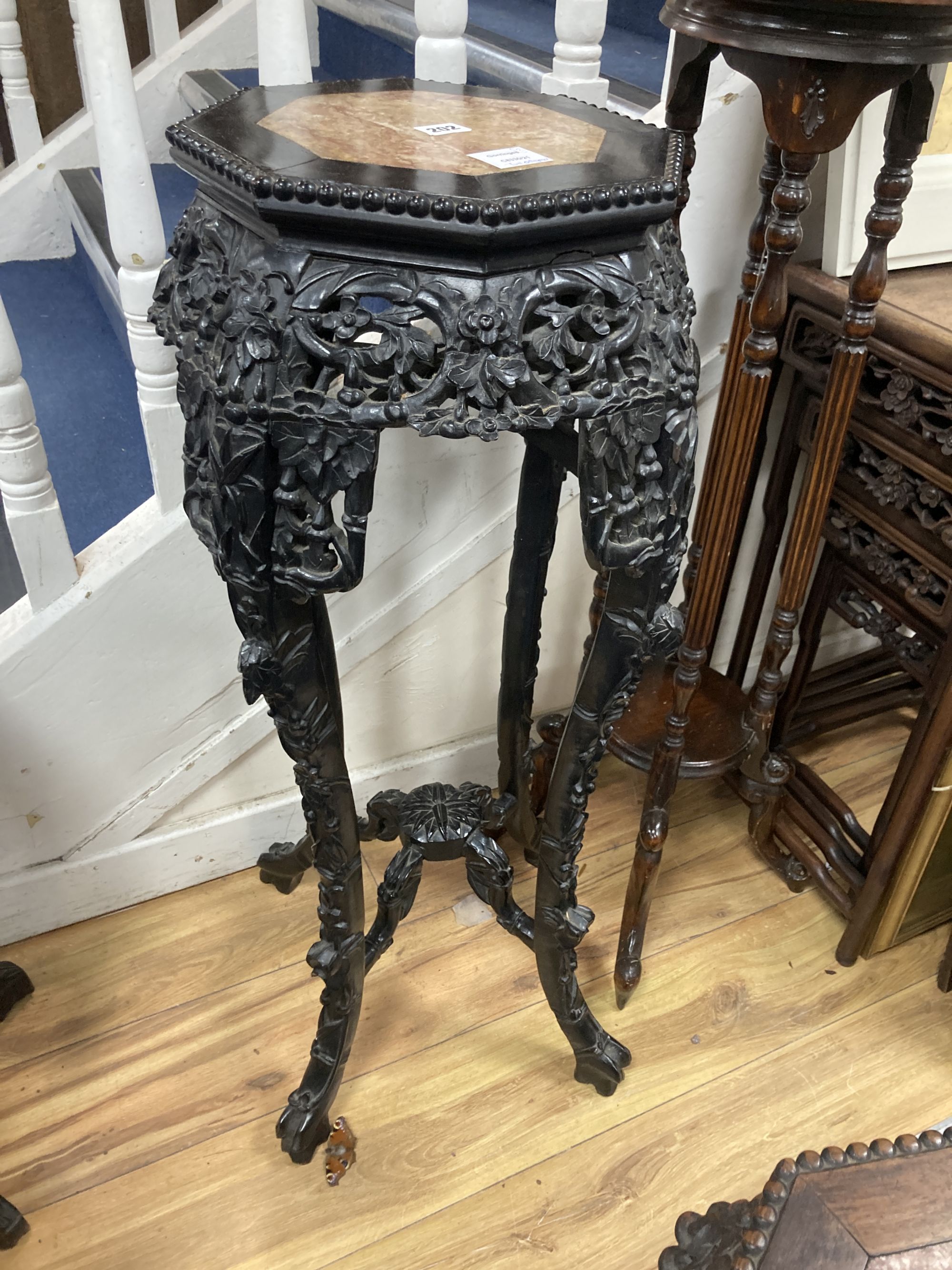 Two Chinese hongmu and marble inset octagonal stands, late 19th century, largest width 40cm height 90cm